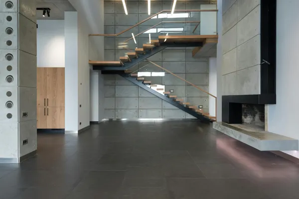 Precision metalwork detail on curved cantilevered staircase in Miami workshop